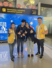 a group of people posing for a photo in an airport