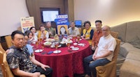 a group of people posing for a picture at a table